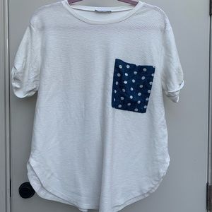 White top with blue pattern pocket